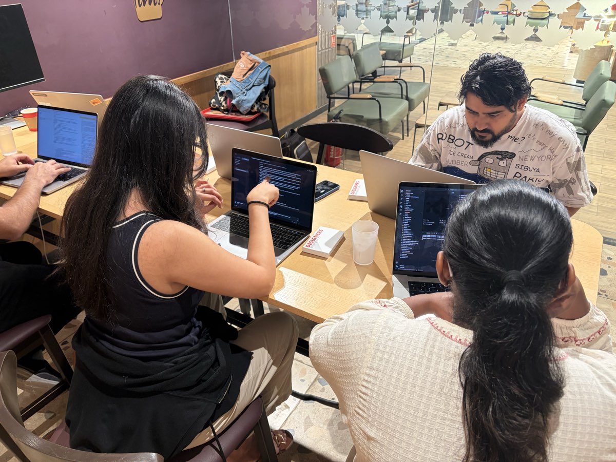 A small Build Day cohort building side by side, code on screen